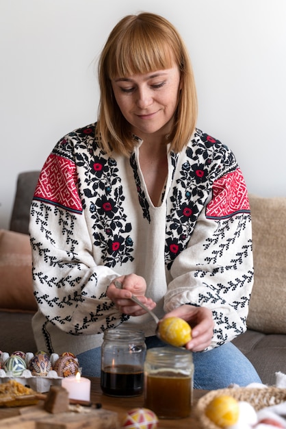 Woman decorating easter eggs