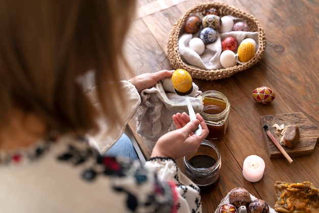 Woman decorating easter eggs