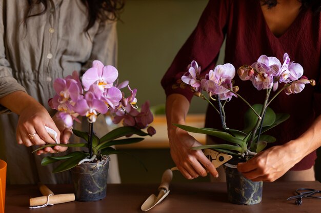 Woman decorating her house with orchids