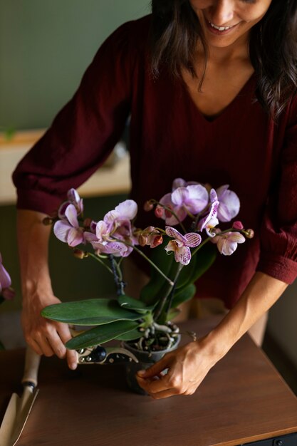 Woman decorating her house with orchids