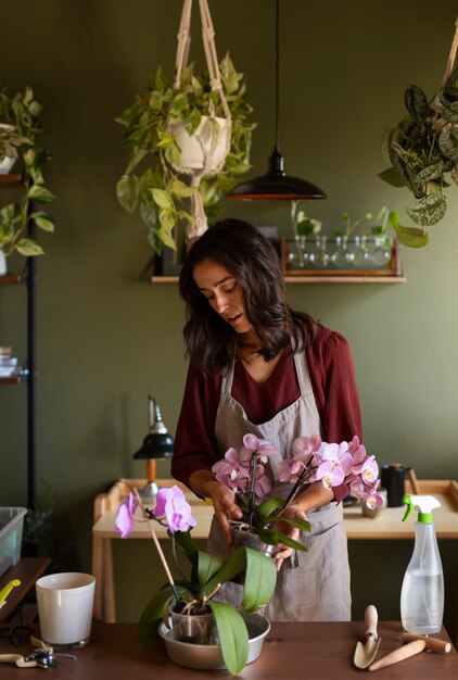 Woman decorating her house with orchids