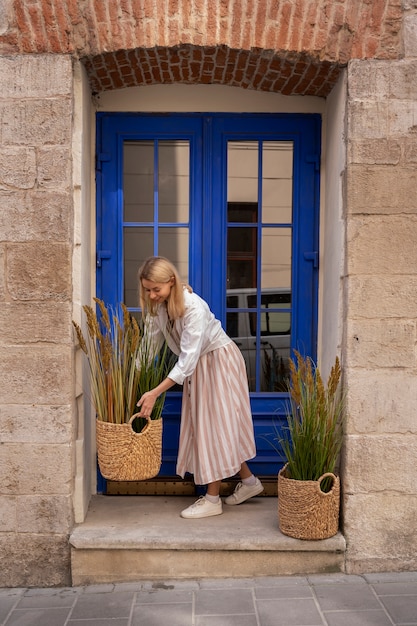 Free photo woman decorating their front door