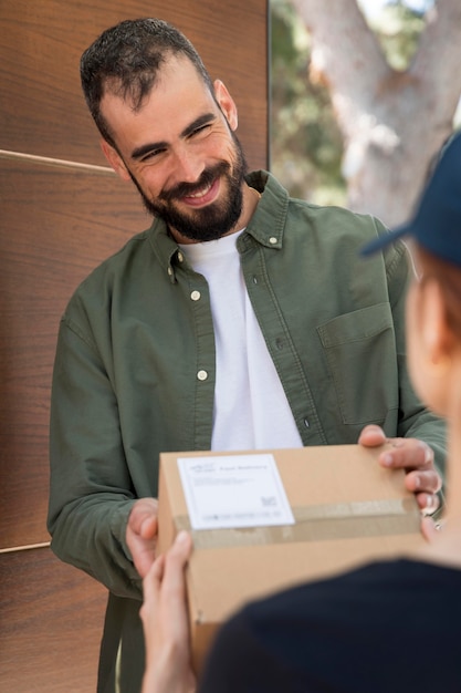 Free Photo woman delivering a package for a man