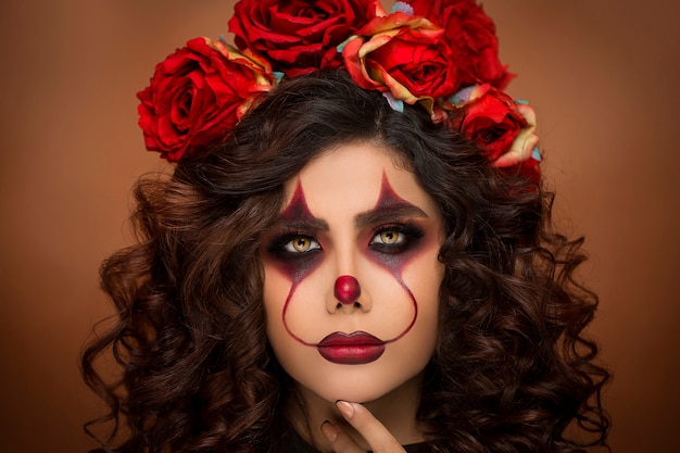 Free photo woman in devil halloween makeup with flower beads