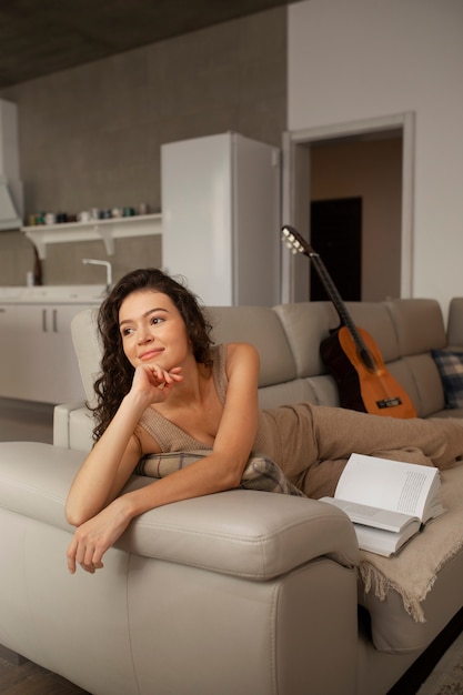 Woman digital disconnecting at home by reading book