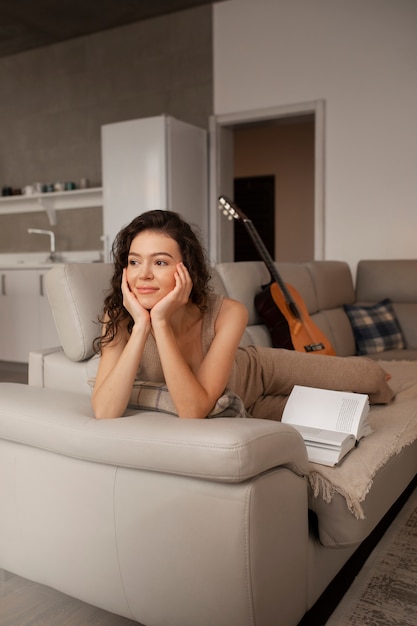 Woman digital disconnecting at home by reading book