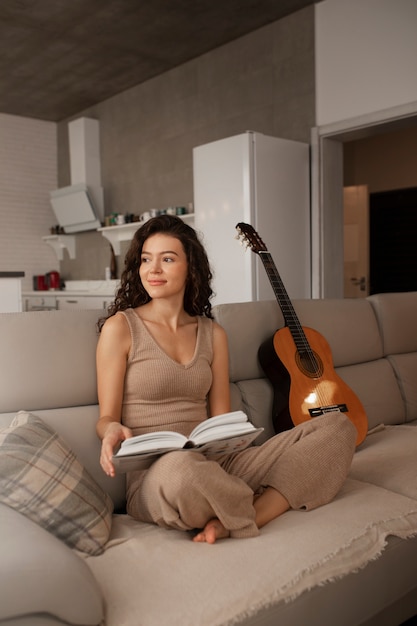 Woman digital disconnecting at home by reading book