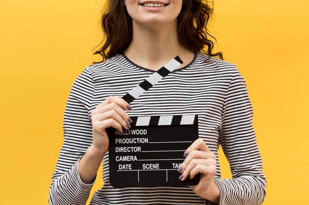 Woman director holding a clapperboard