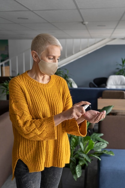 Woman disinfecting before starting to work