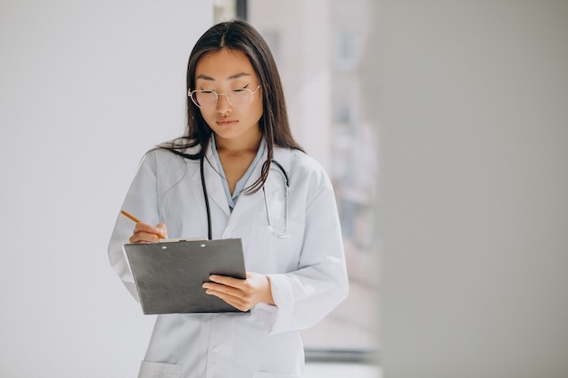 Woman doctor in hospital making notes