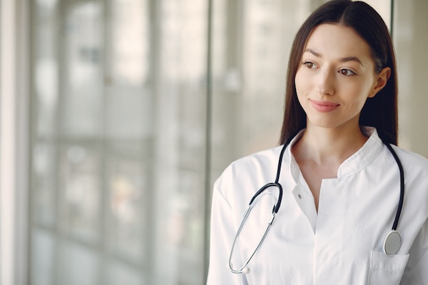 Woman doctor in a white uniform standing in a hall