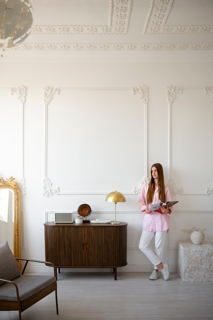 Free Photo woman doing daily activities in minimal decorated room