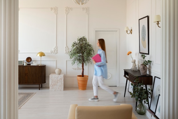 Free photo woman doing daily activities in minimal decorated room