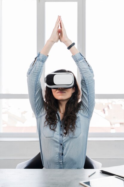 Woman doing exercises with virtual reality headset