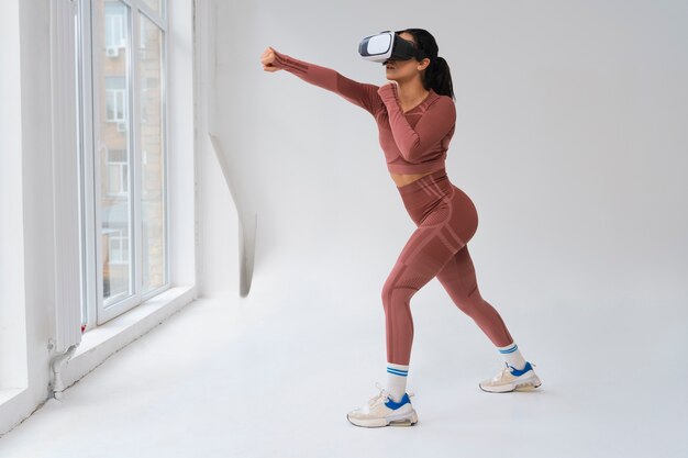 Woman  doing fitness with vr glasses