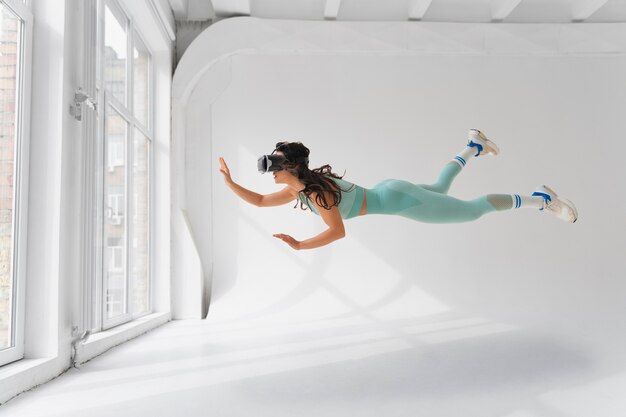 Woman  doing fitness with vr glasses