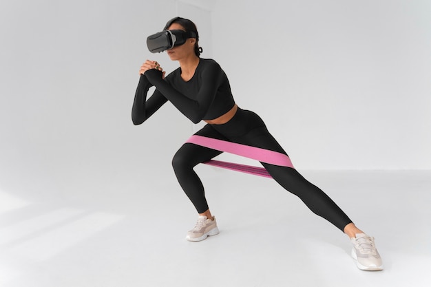 Woman  doing fitness with vr glasses