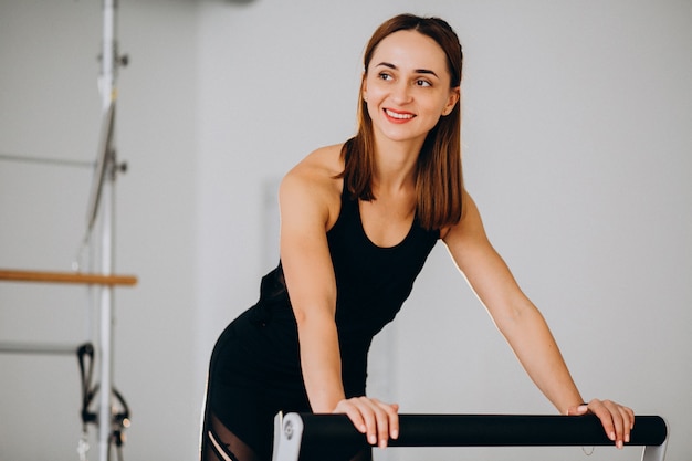 Woman doing pilates on a reformer