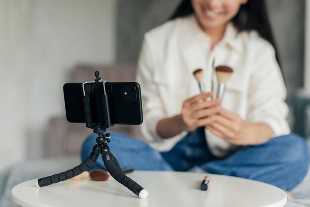 Woman doing a vlog about make up indoors