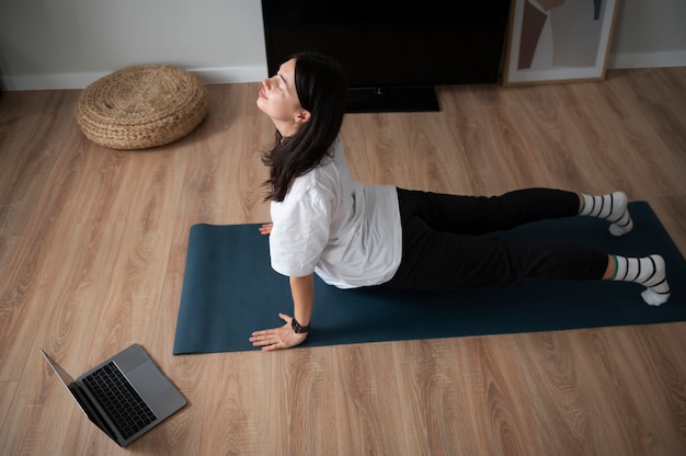 Woman doing yoga at home during quarantine