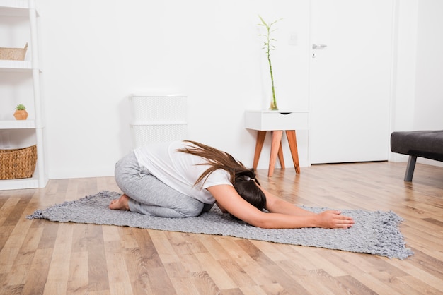 Woman doing yoga at home