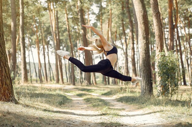 woman doing yoga in a summer forest