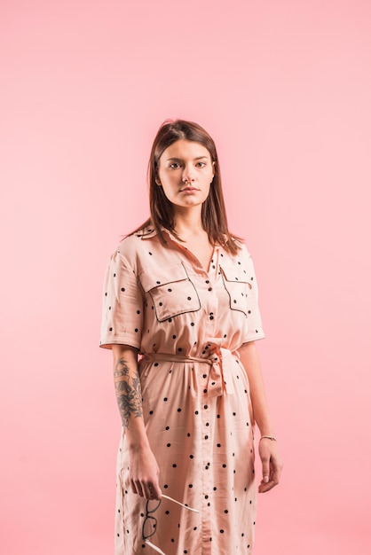 Free photo woman in dress on pink background