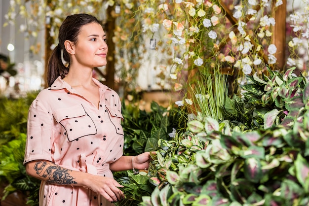 Free photo woman in dress standing in green house