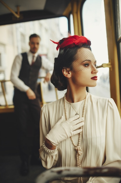 Free Photo woman dressed in a the style of xix century rides in a tram