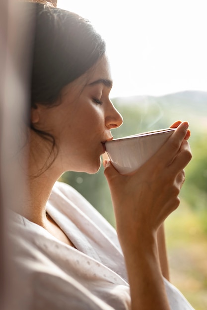 Woman drinking coffee close up