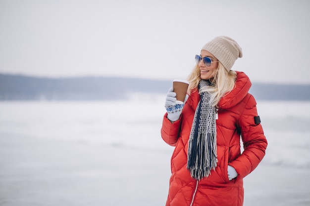 Free Photo woman drinking coffee outside in winter