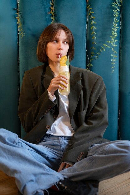 Woman drinking delicious cocktail