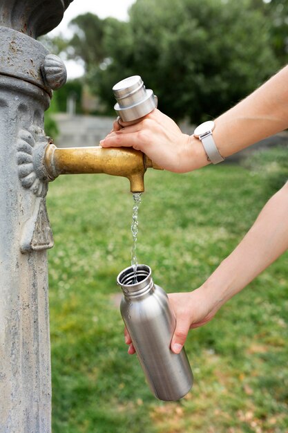 Woman drinking from a sustainable recipient