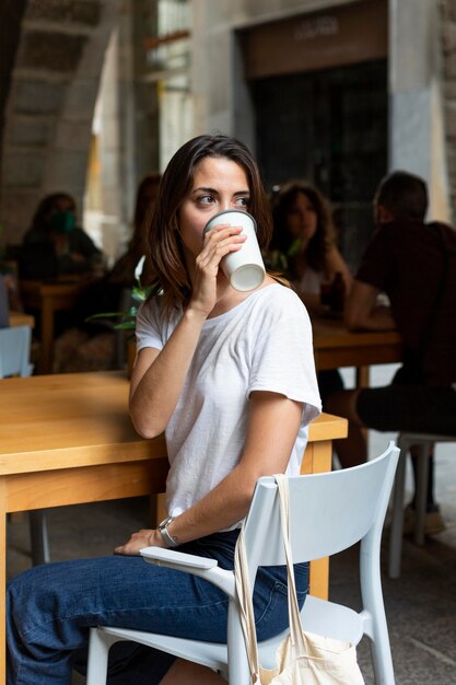 Woman drinking from a sustainable recipient