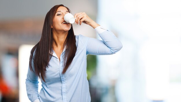 Woman drinking from a white mug