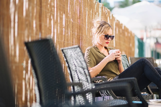 Free photo woman drinking hot beverage on vacation