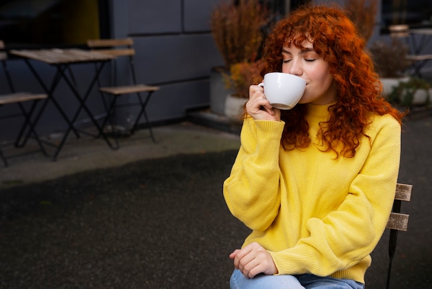 Woman drinking hot chocolate at cafe