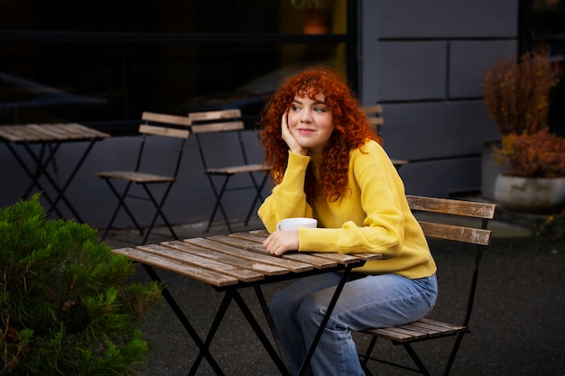 Woman drinking hot chocolate at cafe