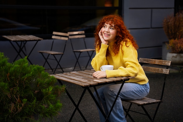 Woman drinking hot chocolate at cafe