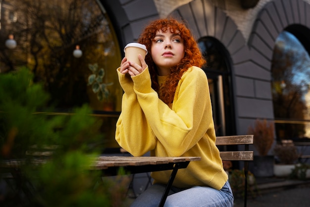 Woman drinking hot chocolate at cafe