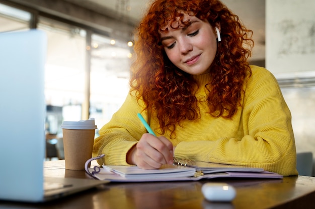 Woman drinking hot chocolate at cafe