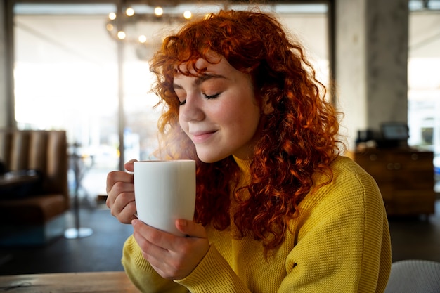 Woman drinking hot chocolate at cafe