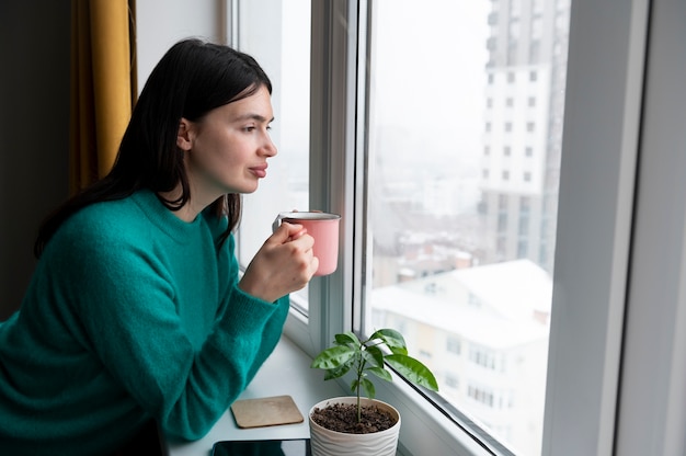 Free Photo woman drinking tea at home during quarantine