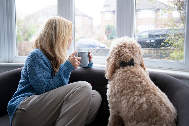 Woman drinking tea while it rains