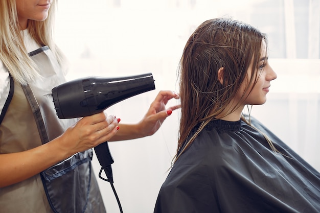 Woman drying hair in a hairsalon