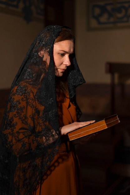 Free photo woman during religious pilgrimage at the church