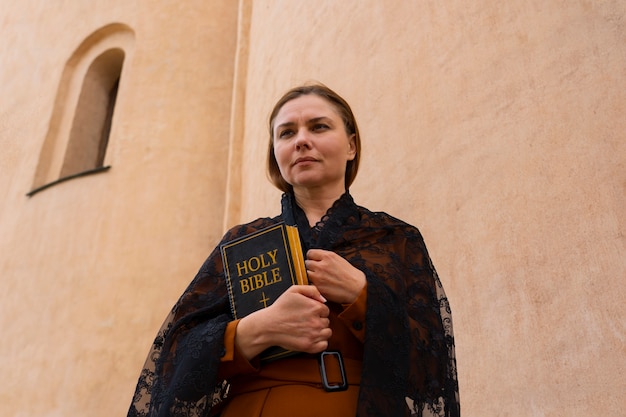 Free photo woman during religious pilgrimage at the church