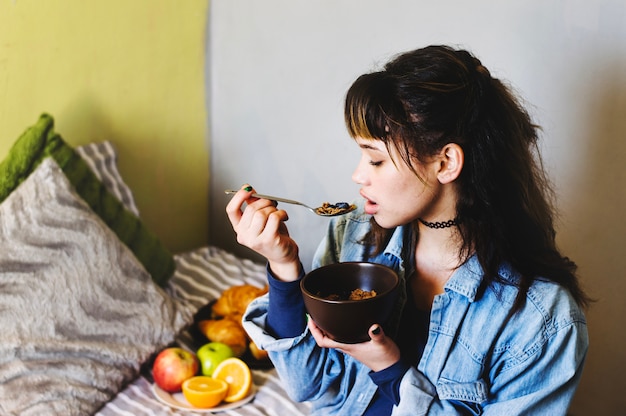 Free photo woman eating cereal at home