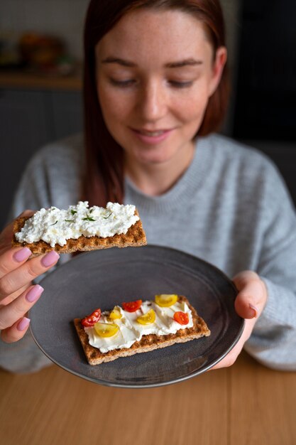 Free photo woman eating delicious cheese high angle