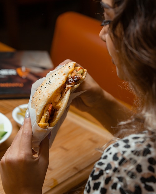 Woman eating kebab